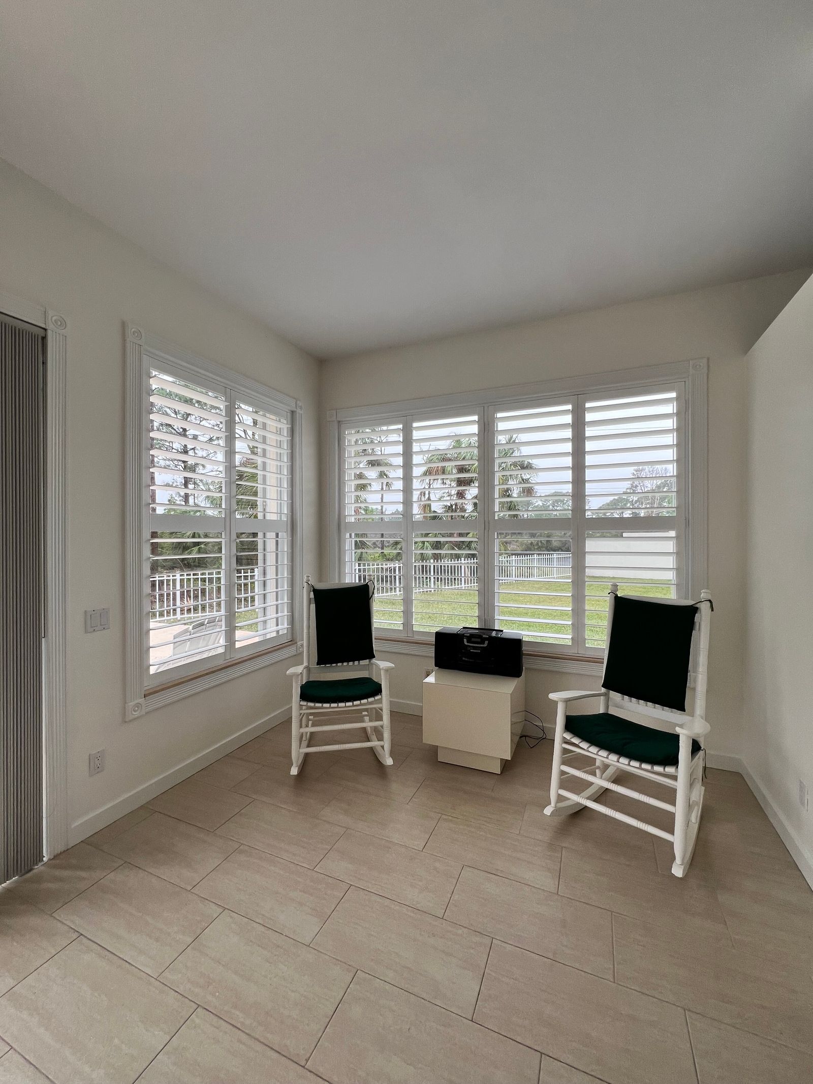 White plantation shutters in a bright Florida sunroom in Monticello